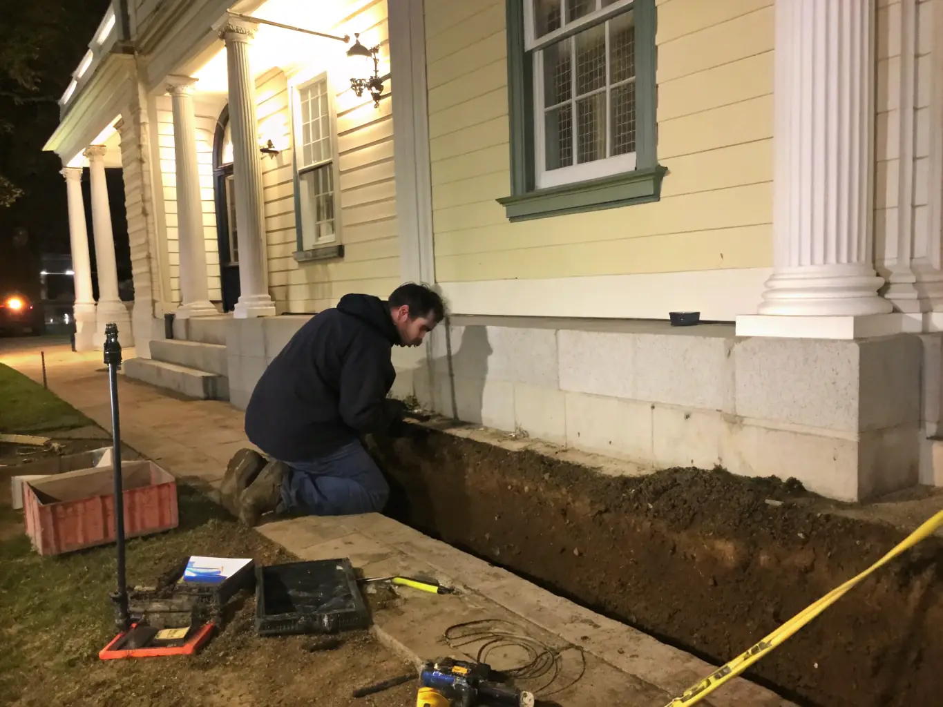 An image of a home's foundation being inspected for structural integrity after water damage, with a technician using specialized tools. The image should convey thoroughness and attention to detail.